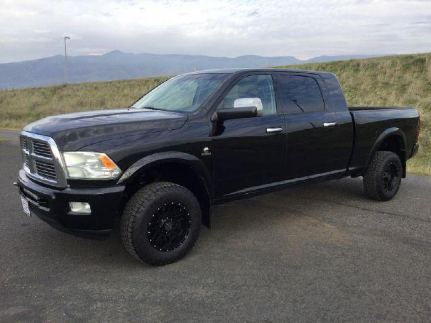 2012 Black RAM 3500 Laramie Longhorn Edition Mega Cab 4WD (3C63D3NL7CG) with an 6.7L L6 OHV 24V TURBO DIESEL engine, 6-Speed Automatic transmission, located at 1801 Main Street, Lewiston, 83501, (208) 743-9371, 46.417065, -117.004799 - Photo#0