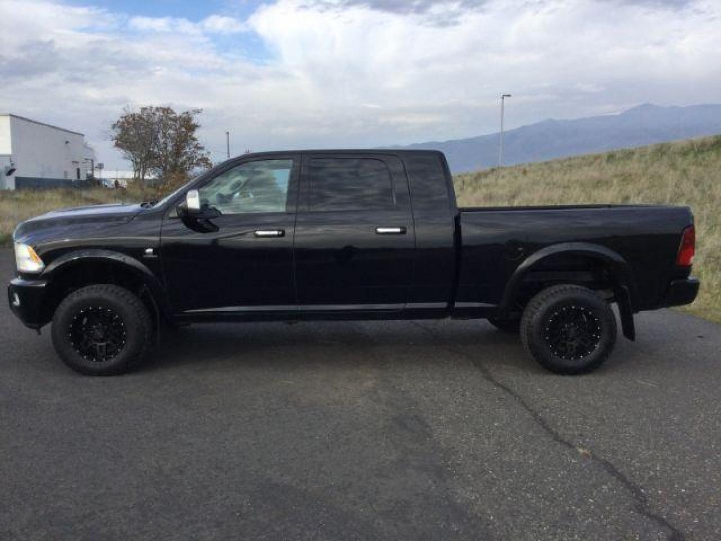 2012 Black RAM 3500 Laramie Longhorn Edition Mega Cab 4WD (3C63D3NL7CG) with an 6.7L L6 OHV 24V TURBO DIESEL engine, 6-Speed Automatic transmission, located at 1801 Main Street, Lewiston, 83501, (208) 743-9371, 46.417065, -117.004799 - Photo#1