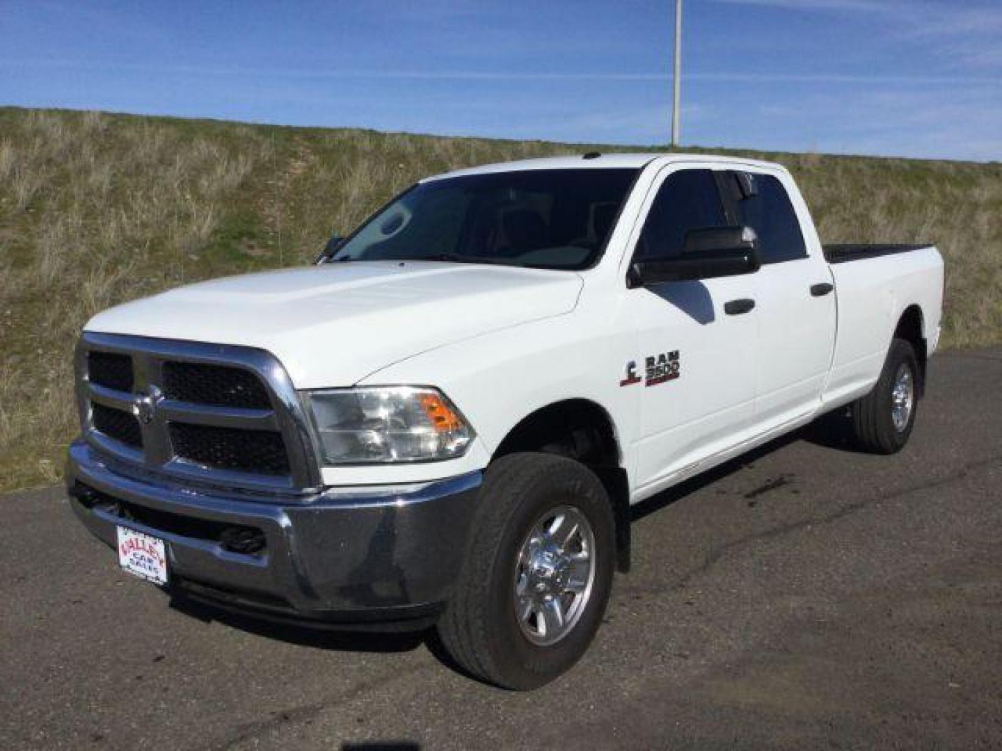 2015 Bright White Clear Coat /Black/Diesel Gray, cloth RAM 3500 SLT Crew Cab LWB 4WD (3C63R3HL2FG) with an 6.7L L6 OHV 24V TURBO DIESEL engine, 6-Speed Automatic transmission, located at 1801 Main Street, Lewiston, 83501, (208) 743-9371, 46.417065, -117.004799 - Photo#0