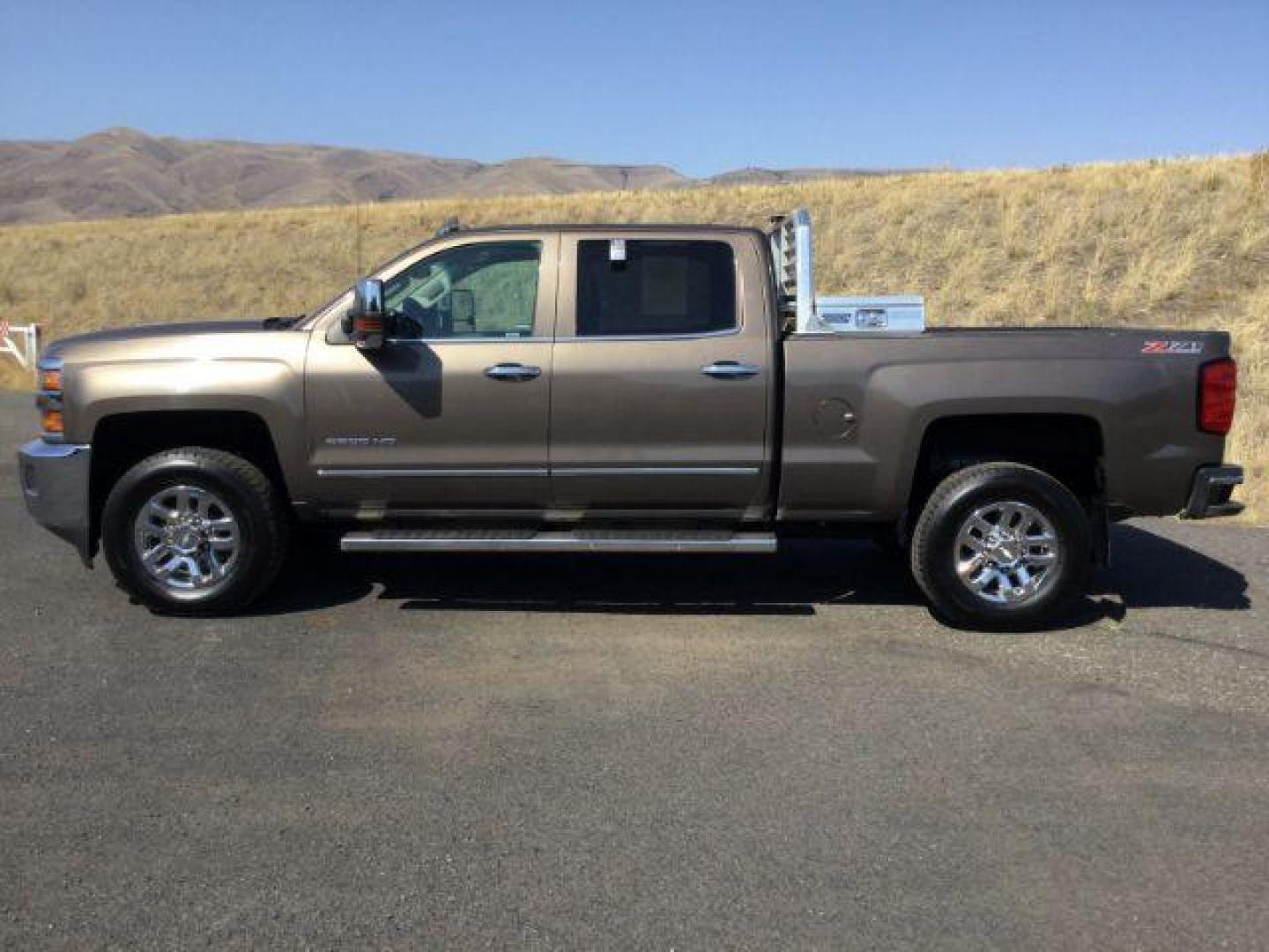 2015 Brownstone Metallic /Cocoa/Dune Chevrolet Silverado 3500HD LTZ Crew Cab 4WD (1GC1K0EG6FF) with an 6.0L V8 OHV 16V FFV engine, 6-Speed Automatic transmission, located at 1801 Main Street, Lewiston, 83501, (208) 743-9371, 46.417065, -117.004799 - Photo#1