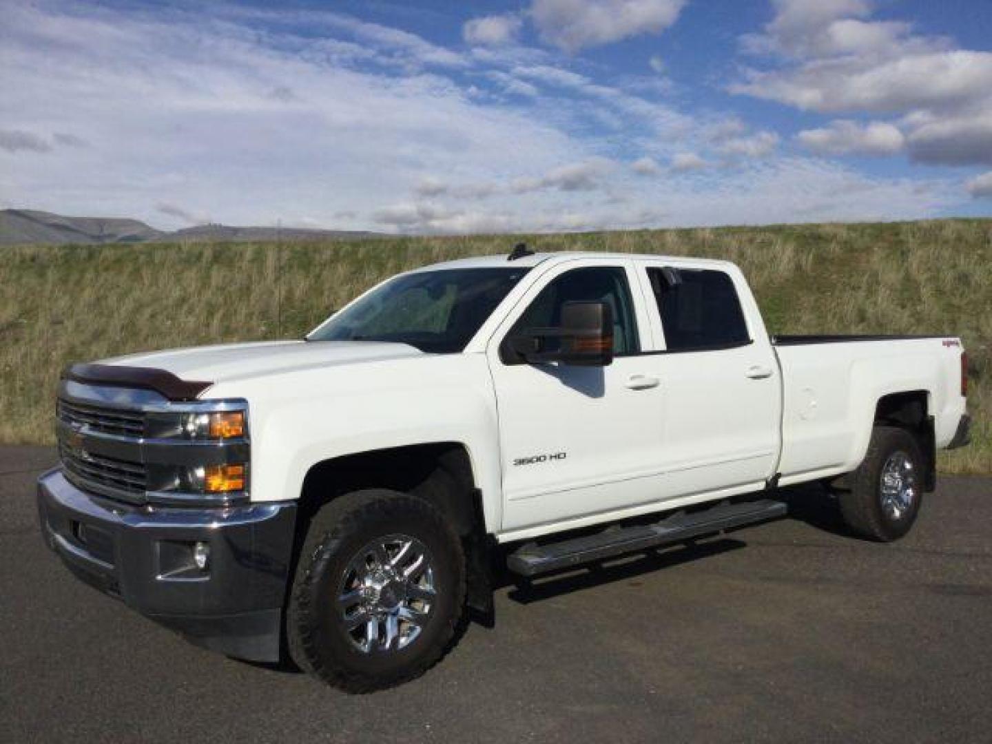 2017 Summit White /Jet Black, cloth Chevrolet Silverado 3500HD LT Crew Cab Long Box 4WD (1GC4KZEG9HF) with an 6.0L V8 OHV 16V FFV engine, 6-Speed Automatic transmission, located at 1801 Main Street, Lewiston, 83501, (208) 743-9371, 46.417065, -117.004799 - Photo#0