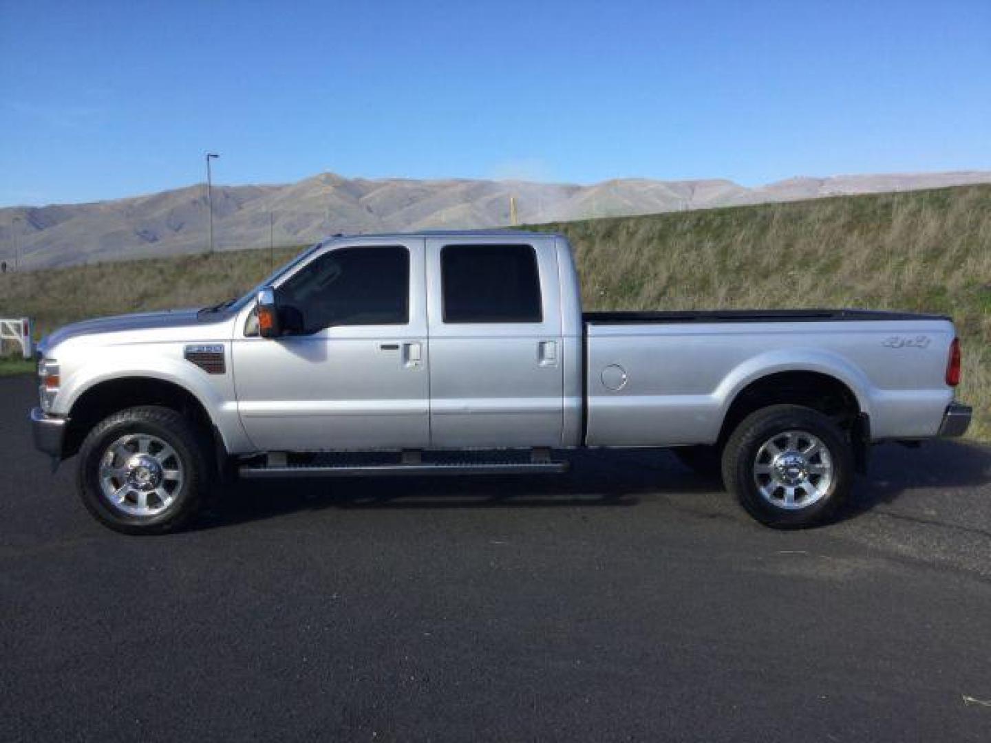 2010 Ingot Silver Metallic /Medium Stone Leather Interior Ford F-350 SD Lariat Crew Cab Long Bed 4WD (1FTWW3BR5AE) with an 6.4L V8 OHV 32V TURBO DIESEL engine, 5-Speed Automatic transmission, located at 1801 Main Street, Lewiston, 83501, (208) 743-9371, 46.417065, -117.004799 - Photo#1