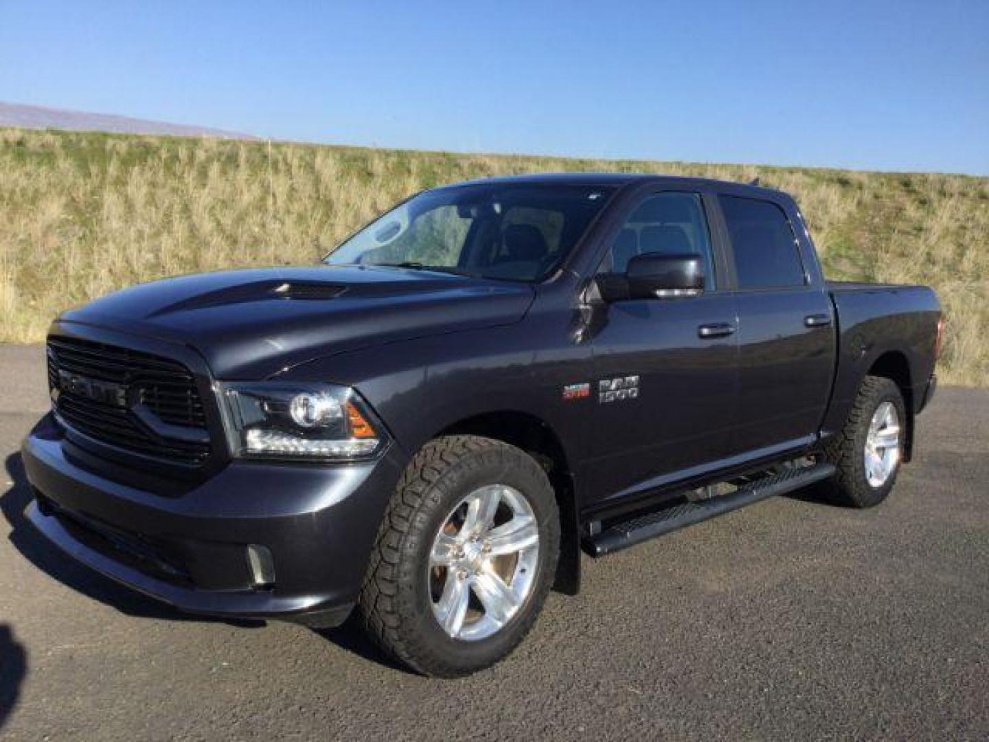 2018 Granite Crystal Metallic Clear Coat /BLACK LEATHER/CLOTH RAM 1500 Sport Crew Cab SWB 4WD (1C6RR7MT3JS) with an 5.7L V8 OHV 16V engine, 8-Speed Automatic transmission, located at 1801 Main Street, Lewiston, 83501, (208) 743-9371, 46.417065, -117.004799 - Photo#0