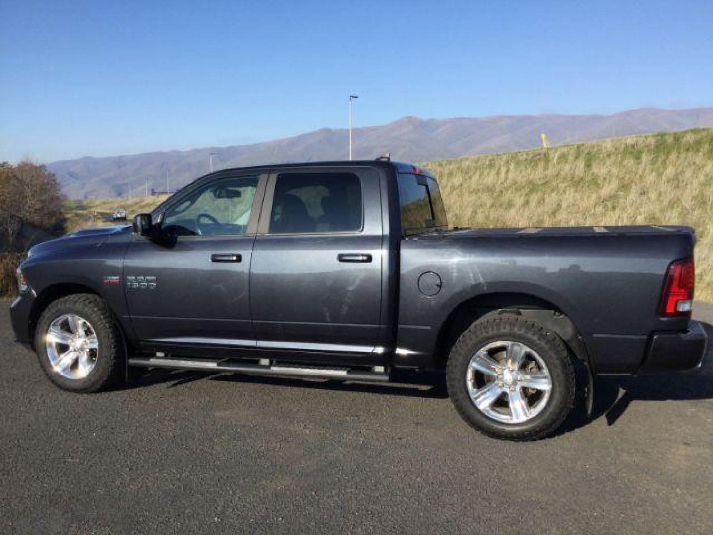 2018 Granite Crystal Metallic Clear Coat /BLACK LEATHER/CLOTH RAM 1500 Sport Crew Cab SWB 4WD (1C6RR7MT3JS) with an 5.7L V8 OHV 16V engine, 8-Speed Automatic transmission, located at 1801 Main Street, Lewiston, 83501, (208) 743-9371, 46.417065, -117.004799 - Photo#1