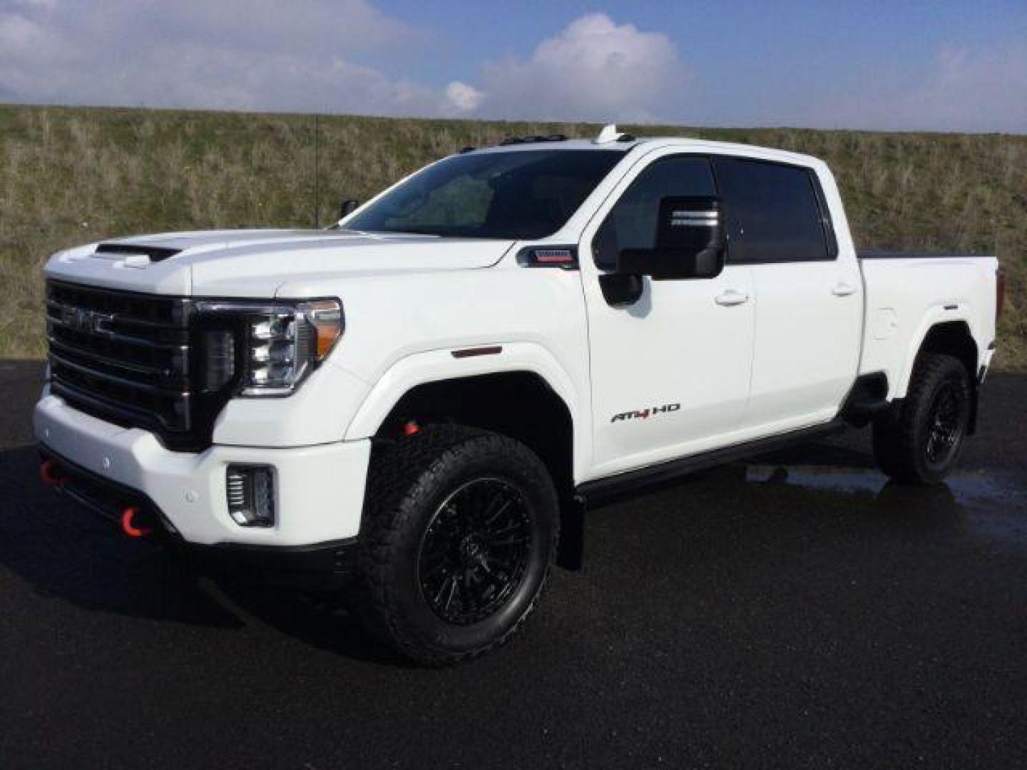 2021 Summit White /Jet Black w/Kalahari Accents GMC Sierra 3500HD AT4 Crew Cab 4WD (1GT49VEY8MF) with an 6.6L V8 OHV 16 DIESEL engine, 10-speed automatic transmission, located at 1801 Main Street, Lewiston, 83501, (208) 743-9371, 46.417065, -117.004799 - Photo#0