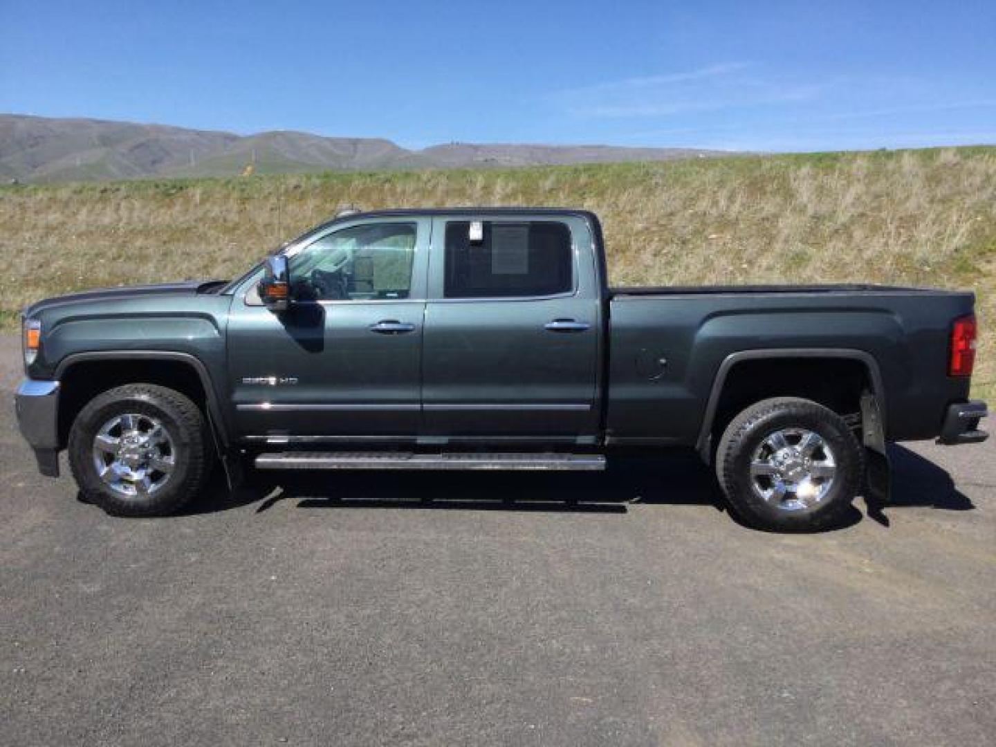 2017 Dark Slate Metallic /Jet Black, leather GMC Sierra 2500HD SLT Crew Cab 4WD (1GT12TEG6HF) with an 6.0L V8 OHV 16V FFV engine, 6-Speed Automatic transmission, located at 1801 Main Street, Lewiston, 83501, (208) 743-9371, 46.417065, -117.004799 - Photo#1