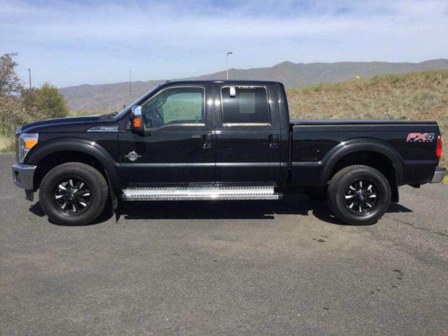 2012 Black /Black Leather Interior Ford F-350 SD Lariat Crew Cab 4WD (1FT8W3BT6CE) with an 6.7L V8 OHV 16V DIESEL engine, 6-Speed Automatic transmission, located at 1801 Main Street, Lewiston, 83501, (208) 743-9371, 46.417065, -117.004799 - Photo#1