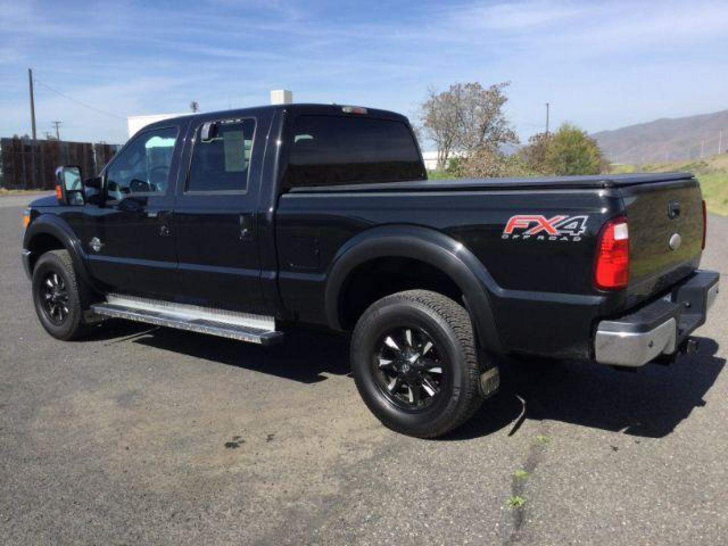 2012 Black /Black Leather Interior Ford F-350 SD Lariat Crew Cab 4WD (1FT8W3BT6CE) with an 6.7L V8 OHV 16V DIESEL engine, 6-Speed Automatic transmission, located at 1801 Main Street, Lewiston, 83501, (208) 743-9371, 46.417065, -117.004799 - Photo#2