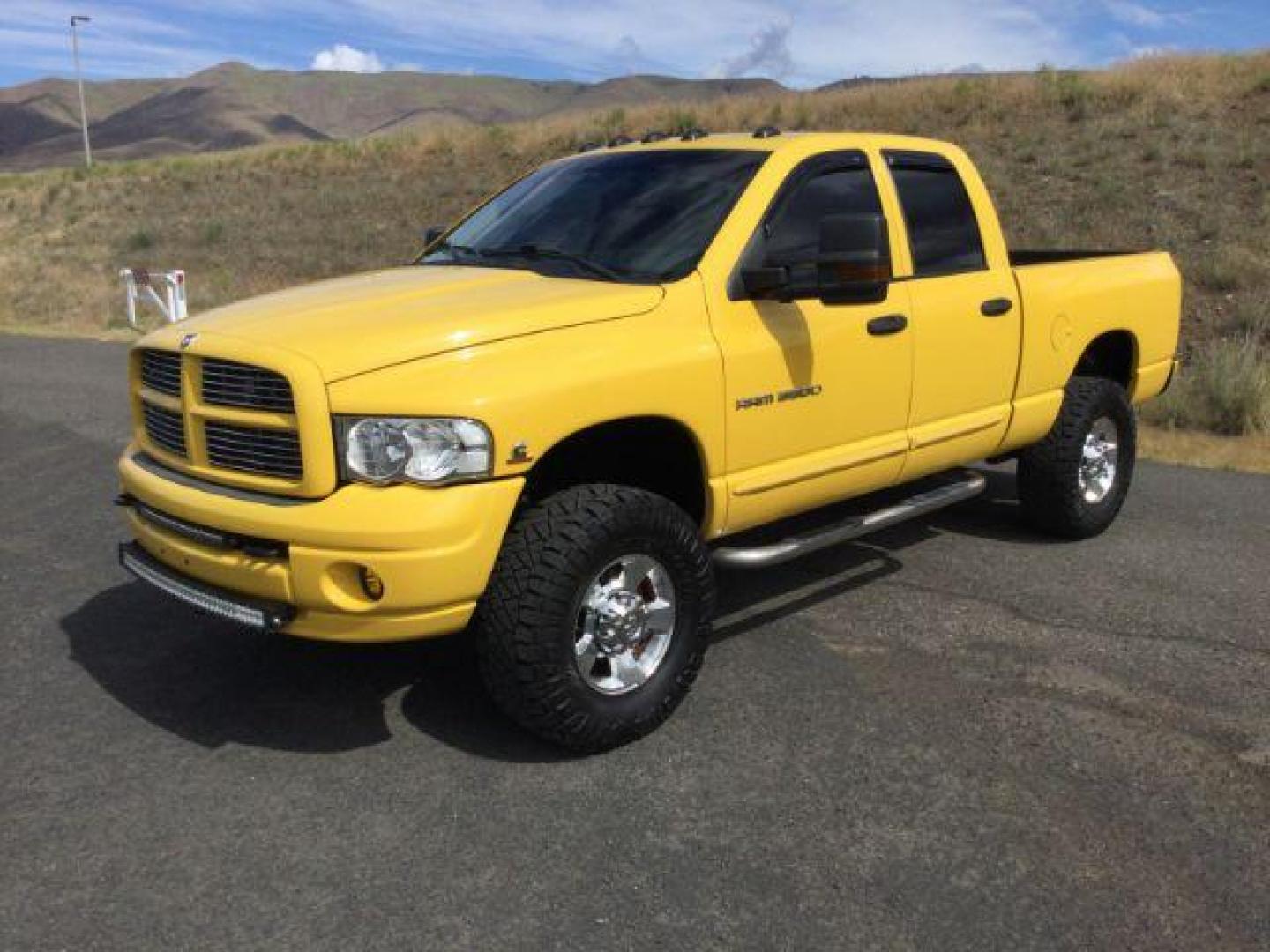 2005 Solar Yellow /Dark Slate Gray Leather Interior Dodge Ram 3500 Laramie Quad Cab Short Bed 4WD (3D7LS38C55G) with an 5.9L L6 OHV 24V TURBO DIESEL engine, 6-Speed Manual transmission, located at 1801 Main Street, Lewiston, 83501, (208) 743-9371, 46.417065, -117.004799 - Photo#0