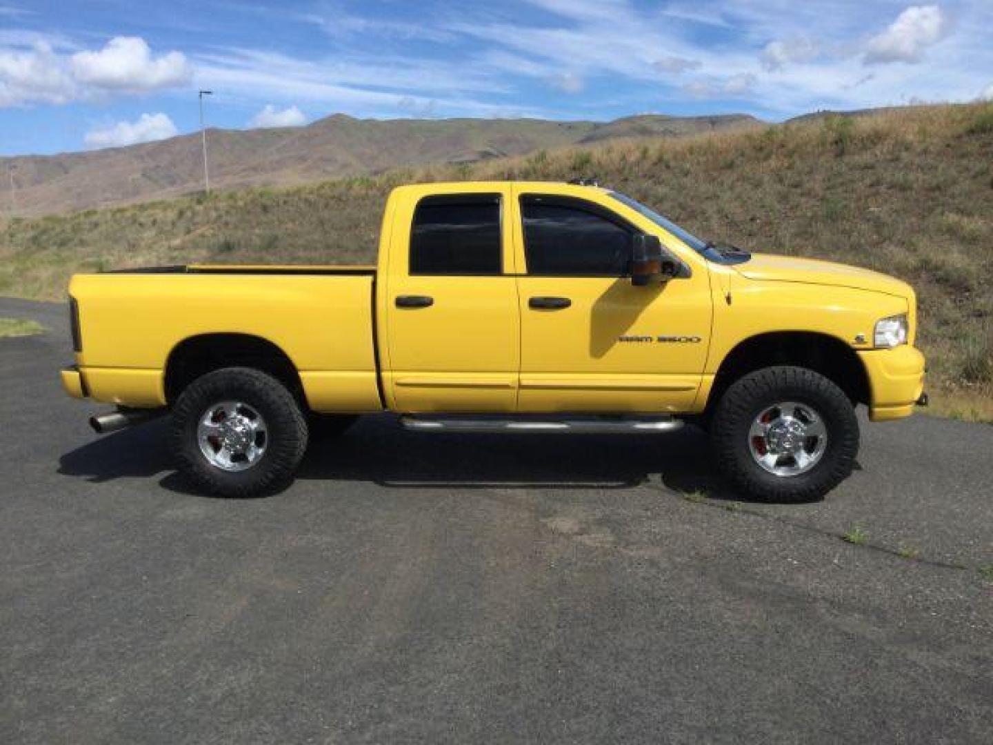 2005 Solar Yellow /Dark Slate Gray Leather Interior Dodge Ram 3500 Laramie Quad Cab Short Bed 4WD (3D7LS38C55G) with an 5.9L L6 OHV 24V TURBO DIESEL engine, 6-Speed Manual transmission, located at 1801 Main Street, Lewiston, 83501, (208) 743-9371, 46.417065, -117.004799 - Photo#11