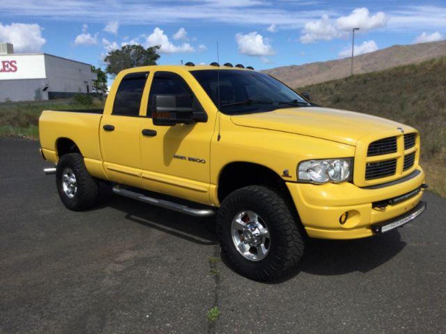 2005 Solar Yellow /Dark Slate Gray Leather Interior Dodge Ram 3500 Laramie Quad Cab Short Bed 4WD (3D7LS38C55G) with an 5.9L L6 OHV 24V TURBO DIESEL engine, 6-Speed Manual transmission, located at 1801 Main Street, Lewiston, 83501, (208) 743-9371, 46.417065, -117.004799 - Photo#12