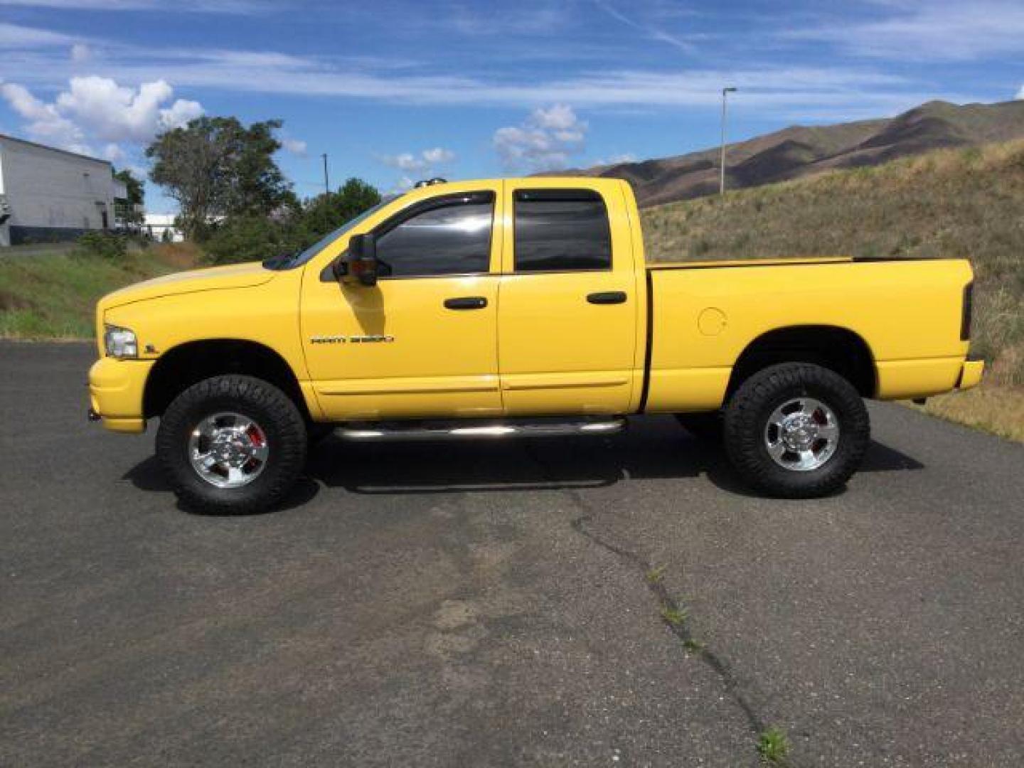 2005 Solar Yellow /Dark Slate Gray Leather Interior Dodge Ram 3500 Laramie Quad Cab Short Bed 4WD (3D7LS38C55G) with an 5.9L L6 OHV 24V TURBO DIESEL engine, 6-Speed Manual transmission, located at 1801 Main Street, Lewiston, 83501, (208) 743-9371, 46.417065, -117.004799 - Photo#1