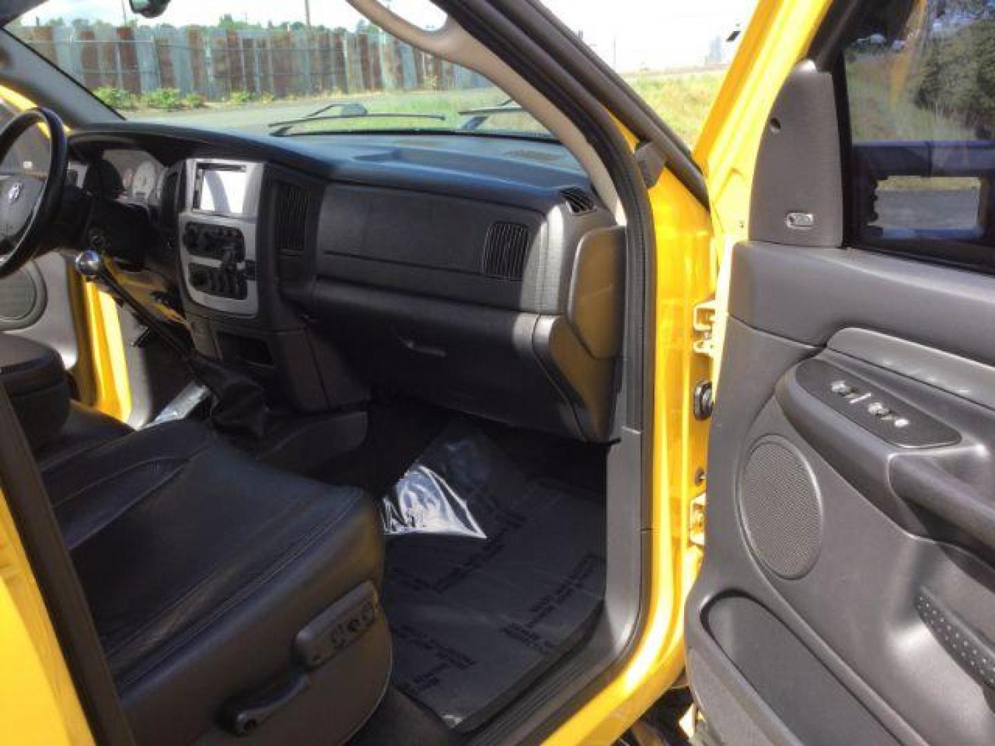 2005 Solar Yellow /Dark Slate Gray Leather Interior Dodge Ram 3500 Laramie Quad Cab Short Bed 4WD (3D7LS38C55G) with an 5.9L L6 OHV 24V TURBO DIESEL engine, 6-Speed Manual transmission, located at 1801 Main Street, Lewiston, 83501, (208) 743-9371, 46.417065, -117.004799 - Photo#22