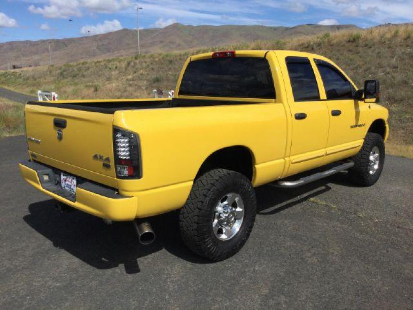 2005 Solar Yellow /Dark Slate Gray Leather Interior Dodge Ram 3500 Laramie Quad Cab Short Bed 4WD (3D7LS38C55G) with an 5.9L L6 OHV 24V TURBO DIESEL engine, 6-Speed Manual transmission, located at 1801 Main Street, Lewiston, 83501, (208) 743-9371, 46.417065, -117.004799 - Photo#24