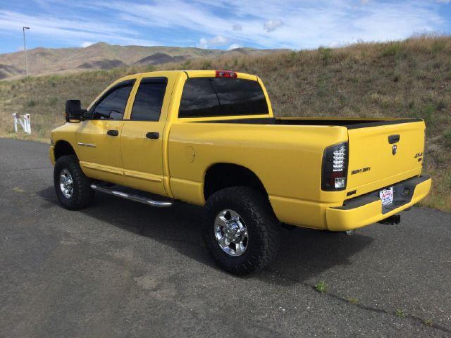 2005 Solar Yellow /Dark Slate Gray Leather Interior Dodge Ram 3500 Laramie Quad Cab Short Bed 4WD (3D7LS38C55G) with an 5.9L L6 OHV 24V TURBO DIESEL engine, 6-Speed Manual transmission, located at 1801 Main Street, Lewiston, 83501, (208) 743-9371, 46.417065, -117.004799 - Photo#2