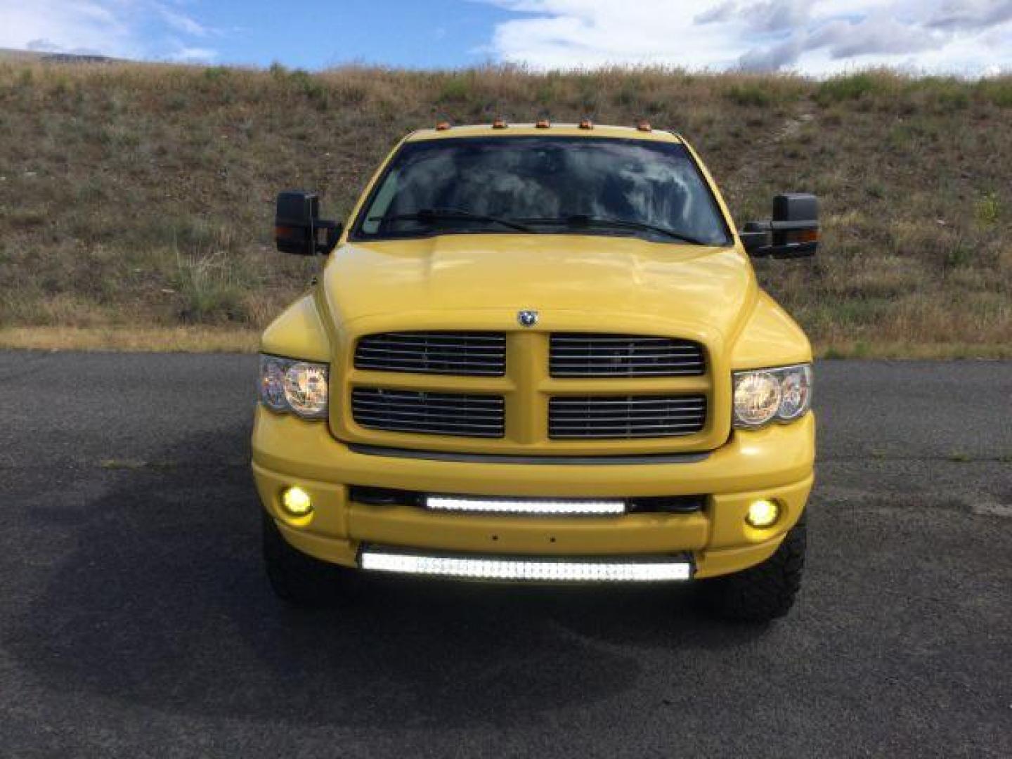 2005 Solar Yellow /Dark Slate Gray Leather Interior Dodge Ram 3500 Laramie Quad Cab Short Bed 4WD (3D7LS38C55G) with an 5.9L L6 OHV 24V TURBO DIESEL engine, 6-Speed Manual transmission, located at 1801 Main Street, Lewiston, 83501, (208) 743-9371, 46.417065, -117.004799 - Photo#4