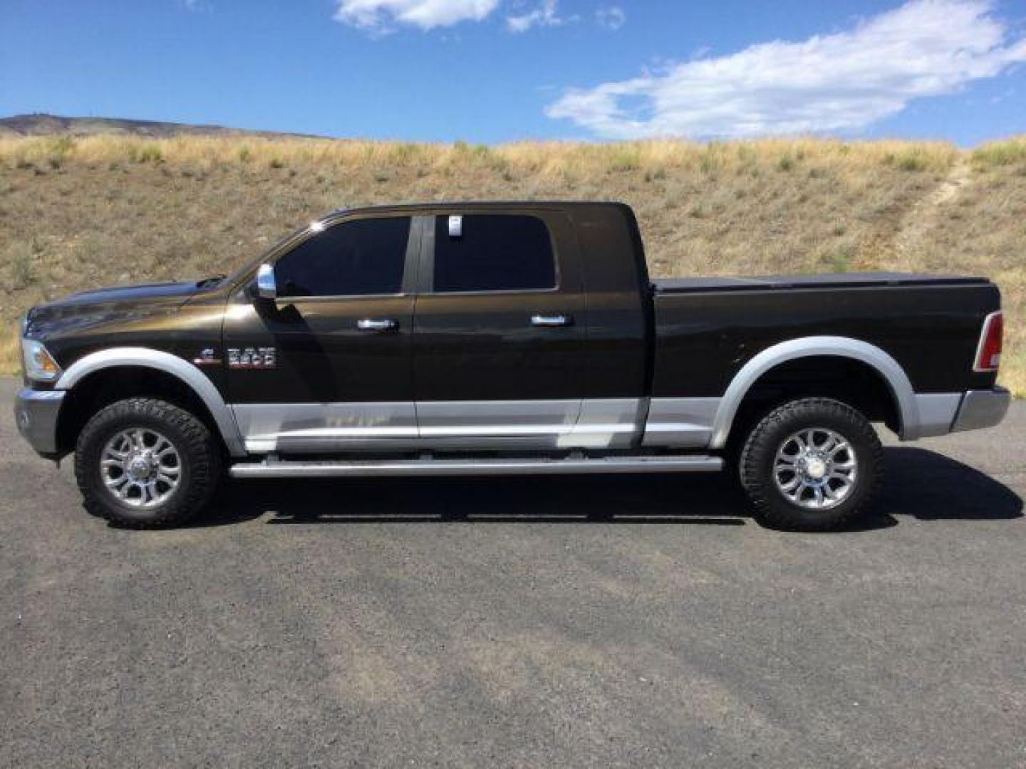 2014 Black Gold Pearlcoat /Black RAM 2500 Laramie Mega Cab 4WD (3C6UR5NL4EG) with an 6.7L L6 OHV 24V TURBO DIESEL engine, 6-Speed Automatic transmission, located at 1801 Main Street, Lewiston, 83501, (208) 743-9371, 46.417065, -117.004799 - Photo#1