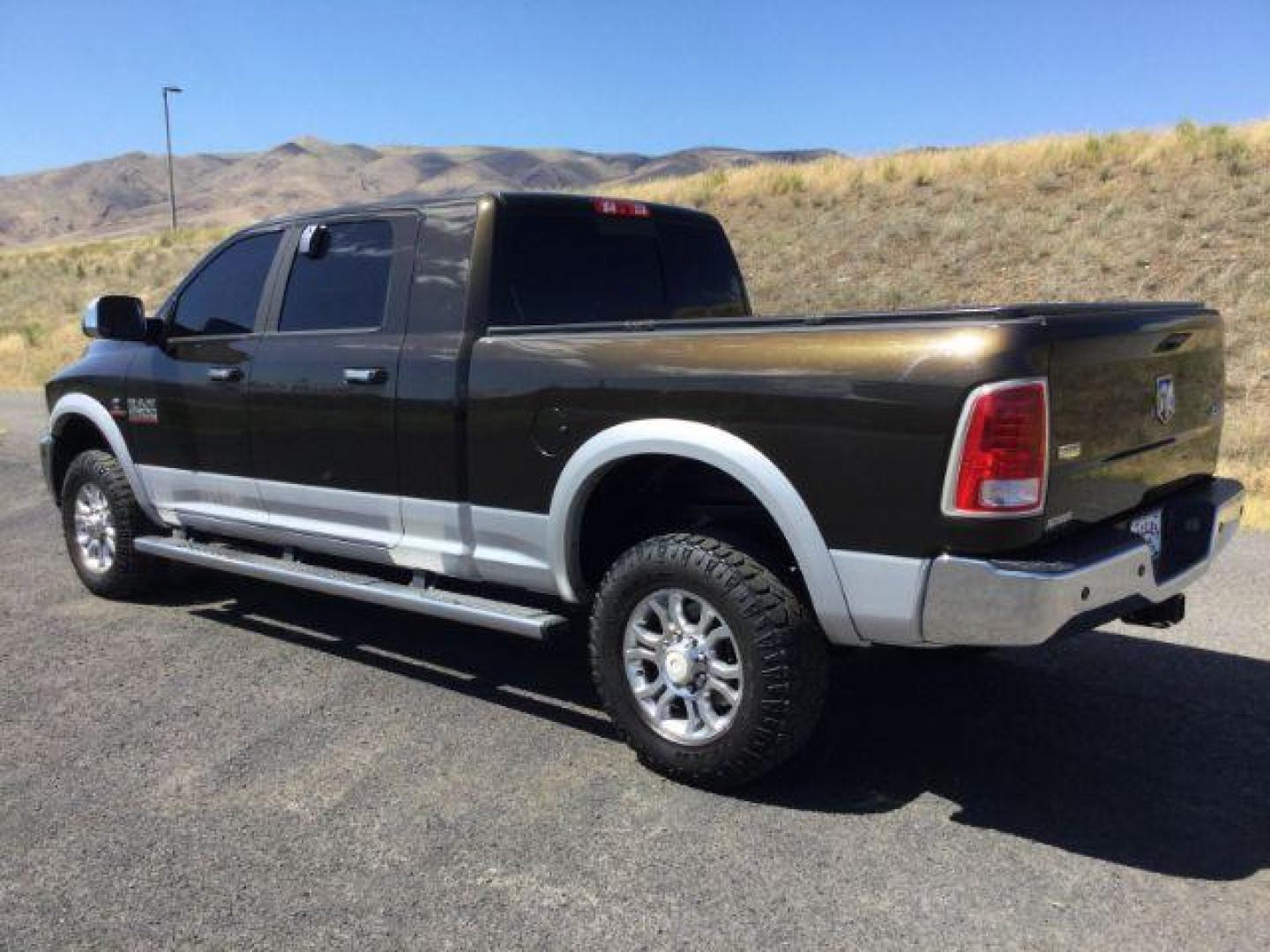 2014 Black Gold Pearlcoat /Black RAM 2500 Laramie Mega Cab 4WD (3C6UR5NL4EG) with an 6.7L L6 OHV 24V TURBO DIESEL engine, 6-Speed Automatic transmission, located at 1801 Main Street, Lewiston, 83501, (208) 743-9371, 46.417065, -117.004799 - Photo#2