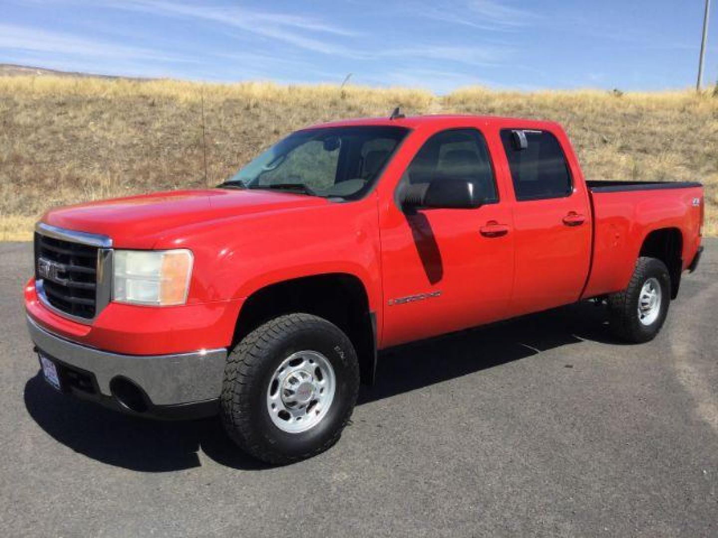 2007 Fire Red /Tan Leather GMC Sierra 2500HD SLE1 Crew Cab 4WD (1GTHK23KX7F) with an 6.0L V8 16V OHV engine, 6-Speed Automatic transmission, located at 1801 Main Street, Lewiston, 83501, (208) 743-9371, 46.417065, -117.004799 - Photo#0