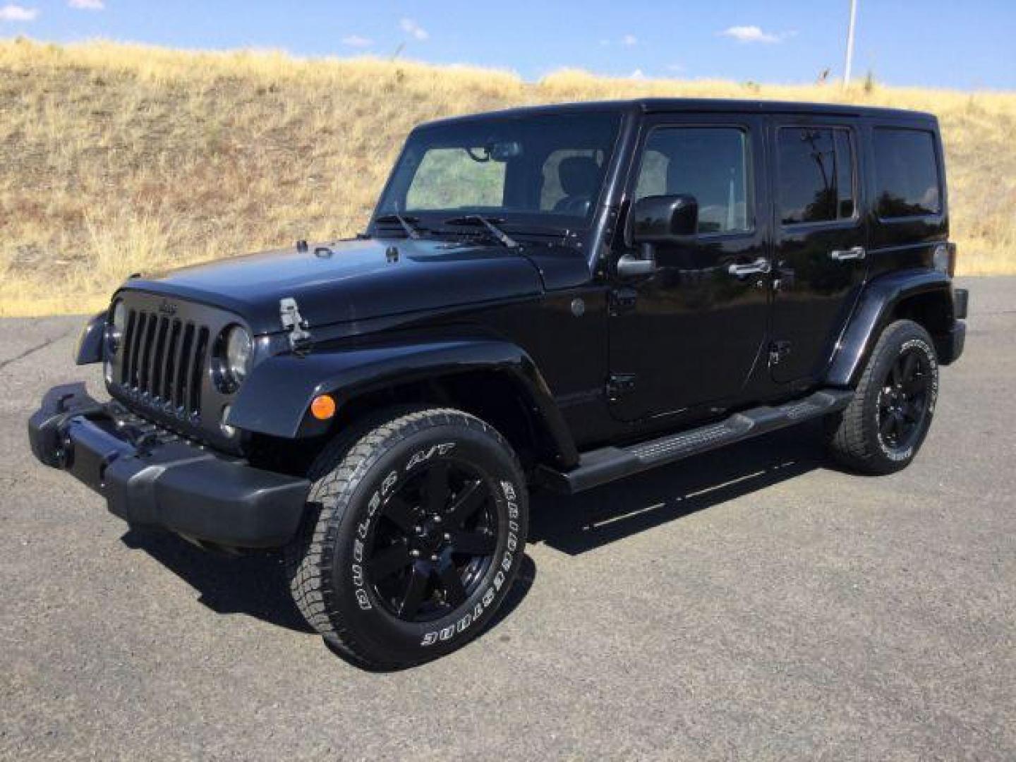 2014 Black Clearcoat /Black Jeep Wrangler Unlimited Sahara 4WD (1C4BJWEG7EL) with an 3.6L V6 DOHC 24V FFV engine, 5-Speed Automatic transmission, located at 1801 Main Street, Lewiston, 83501, (208) 743-9371, 46.417065, -117.004799 - Photo#0