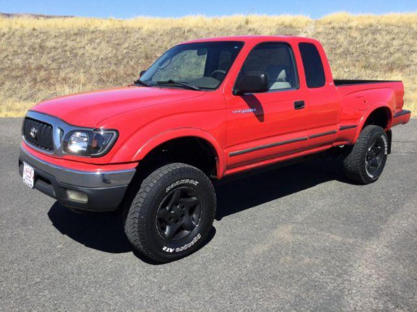 2001 Impulse Red /Oak Cloth Toyota Tacoma Xtracab V6 4WD (5TEWN72N11Z) with an 3.4L V6 DOHC 24V engine, 5-Speed Manual transmission, located at 1801 Main Street, Lewiston, 83501, (208) 743-9371, 46.417065, -117.004799 - Photo#0