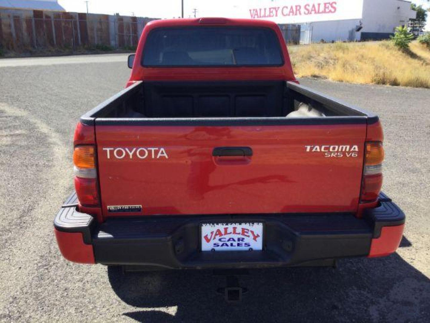 2001 Impulse Red /Oak Cloth Toyota Tacoma Xtracab V6 4WD (5TEWN72N11Z) with an 3.4L V6 DOHC 24V engine, 5-Speed Manual transmission, located at 1801 Main Street, Lewiston, 83501, (208) 743-9371, 46.417065, -117.004799 - Photo#5