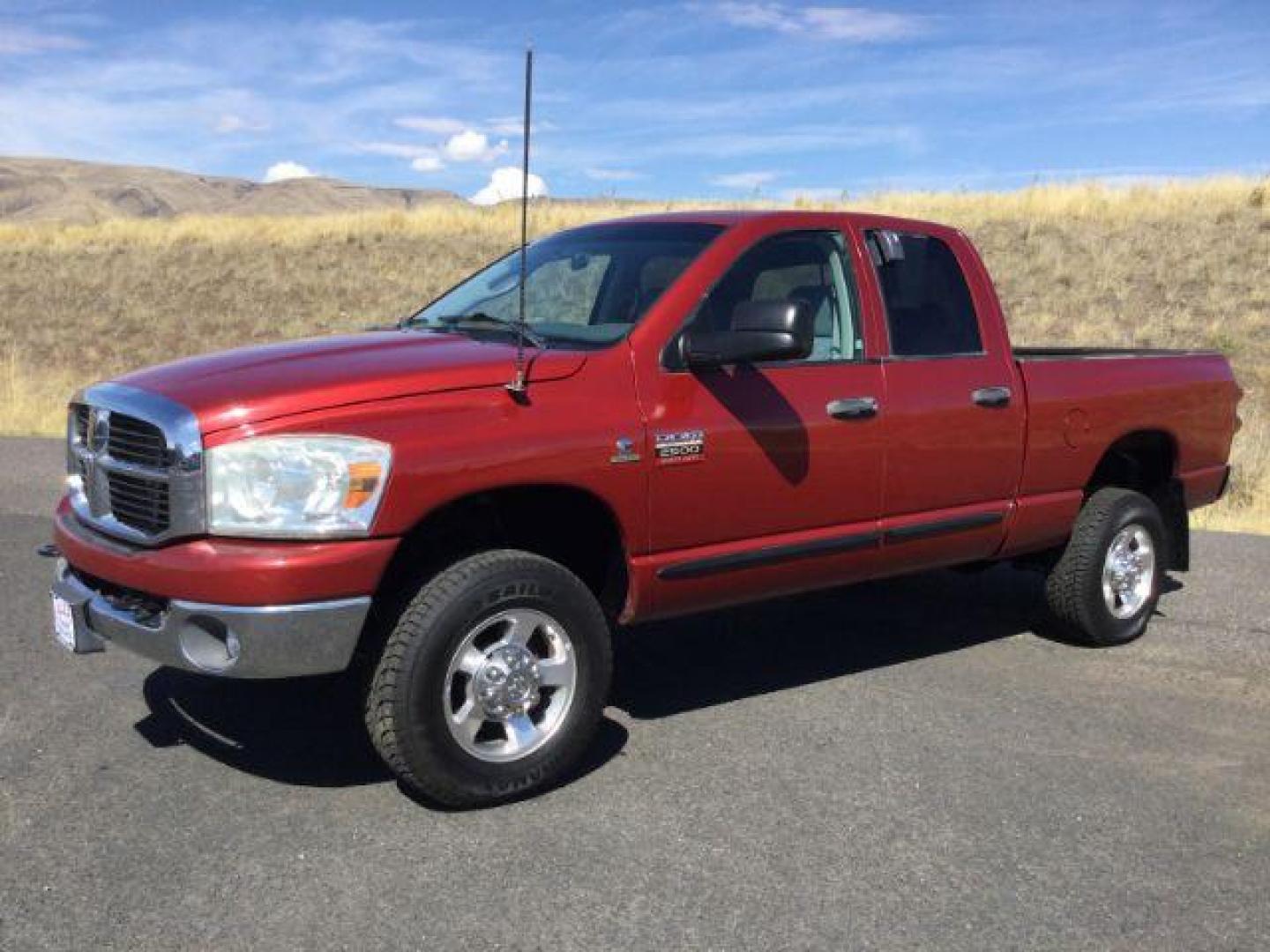 2007 Inferno Red Crystal Pearl Coat /Medium Slate Gray Cloth Interior Dodge Ram 2500 SLT Quad Cab 4WD (3D7KS28A37G) with an 6.7L L6 OHV 24V TURBO DIESEL engine, 6-Speed Manual transmission, located at 1801 Main Street, Lewiston, 83501, (208) 743-9371, 46.417065, -117.004799 - Photo#0