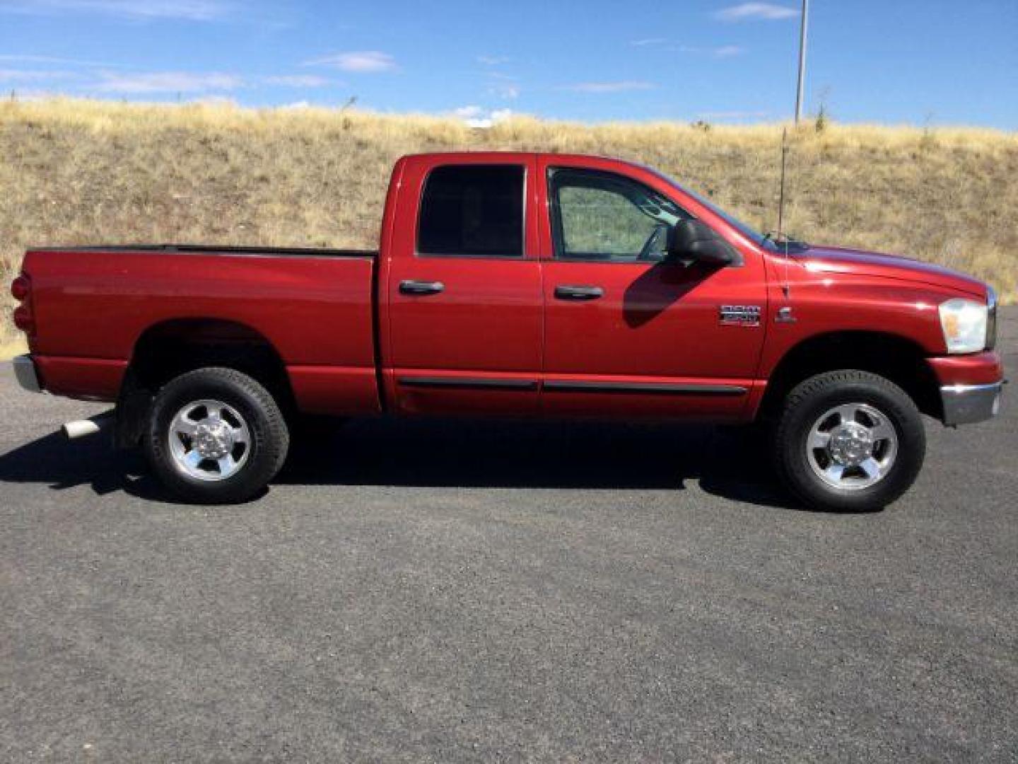 2007 Inferno Red Crystal Pearl Coat /Medium Slate Gray Cloth Interior Dodge Ram 2500 SLT Quad Cab 4WD (3D7KS28A37G) with an 6.7L L6 OHV 24V TURBO DIESEL engine, 6-Speed Manual transmission, located at 1801 Main Street, Lewiston, 83501, (208) 743-9371, 46.417065, -117.004799 - Photo#9