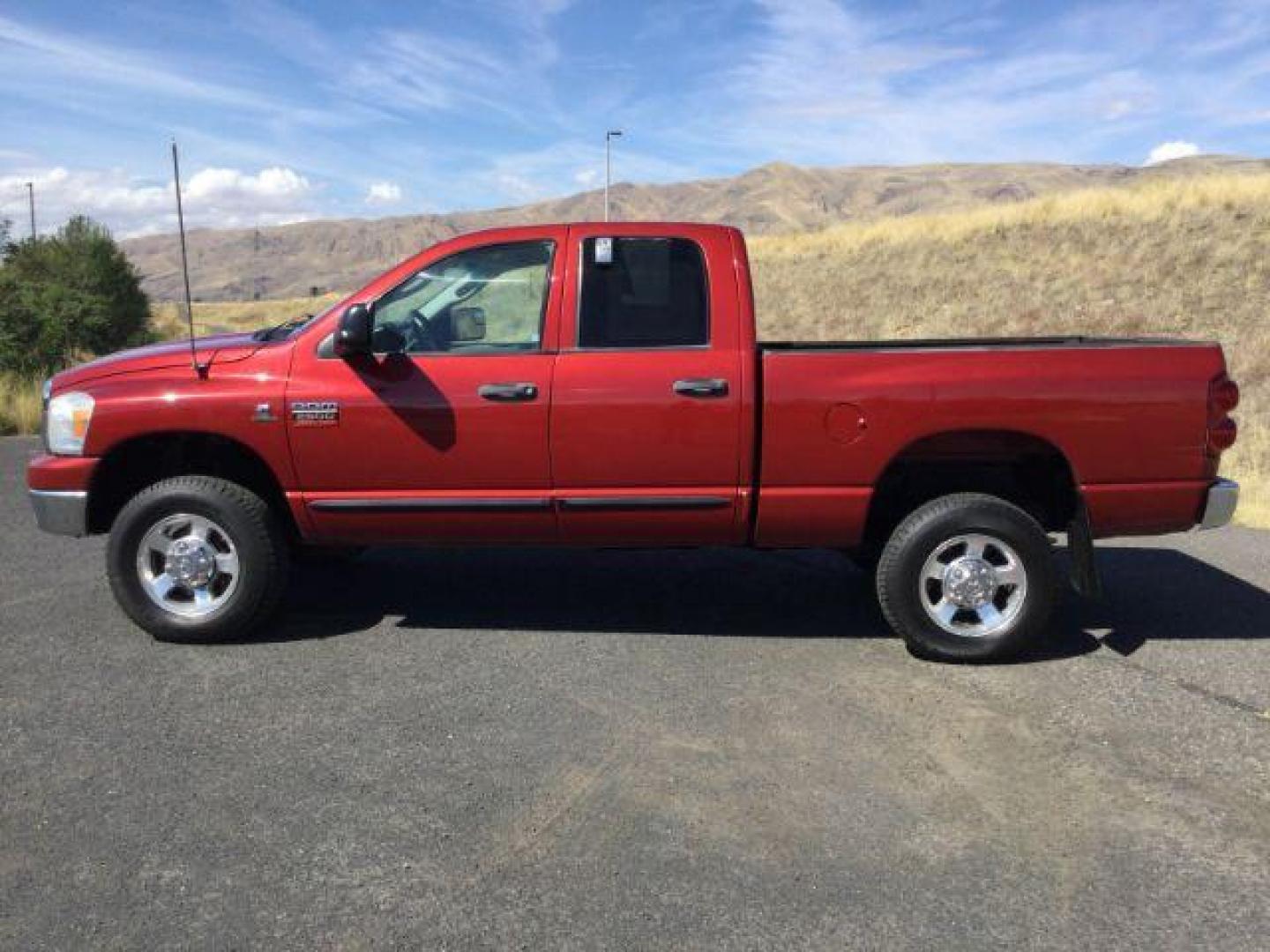 2007 Inferno Red Crystal Pearl Coat /Medium Slate Gray Cloth Interior Dodge Ram 2500 SLT Quad Cab 4WD (3D7KS28A37G) with an 6.7L L6 OHV 24V TURBO DIESEL engine, 6-Speed Manual transmission, located at 1801 Main Street, Lewiston, 83501, (208) 743-9371, 46.417065, -117.004799 - Photo#1