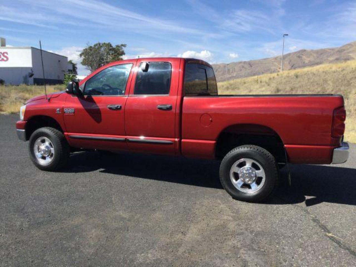 2007 Inferno Red Crystal Pearl Coat /Medium Slate Gray Cloth Interior Dodge Ram 2500 SLT Quad Cab 4WD (3D7KS28A37G) with an 6.7L L6 OHV 24V TURBO DIESEL engine, 6-Speed Manual transmission, located at 1801 Main Street, Lewiston, 83501, (208) 743-9371, 46.417065, -117.004799 - Photo#2