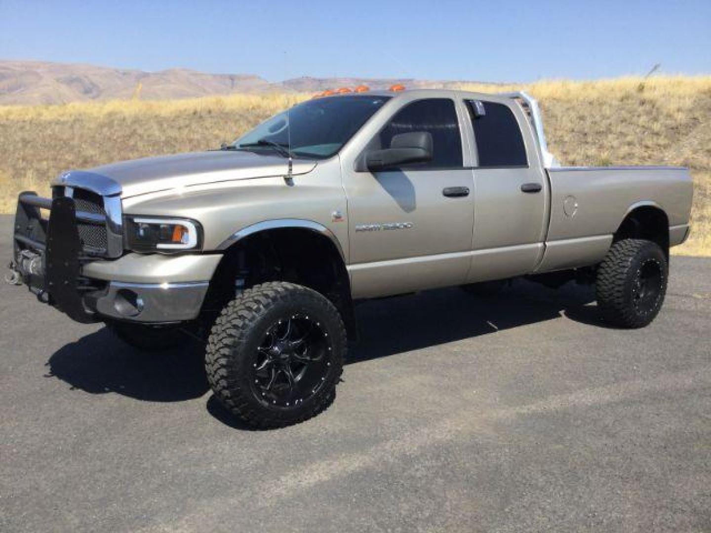 2005 Light Almond Pearl Metallic /Taupe Cloth Interior Dodge Ram 3500 SLT Quad Cab Long Bed 4WD (3D7LS38C25G) with an 5.9L L6 OHV 24V TURBO DIESEL engine, 6-Speed Manual transmission, located at 1801 Main Street, Lewiston, 83501, (208) 743-9371, 46.417065, -117.004799 - Photo#0