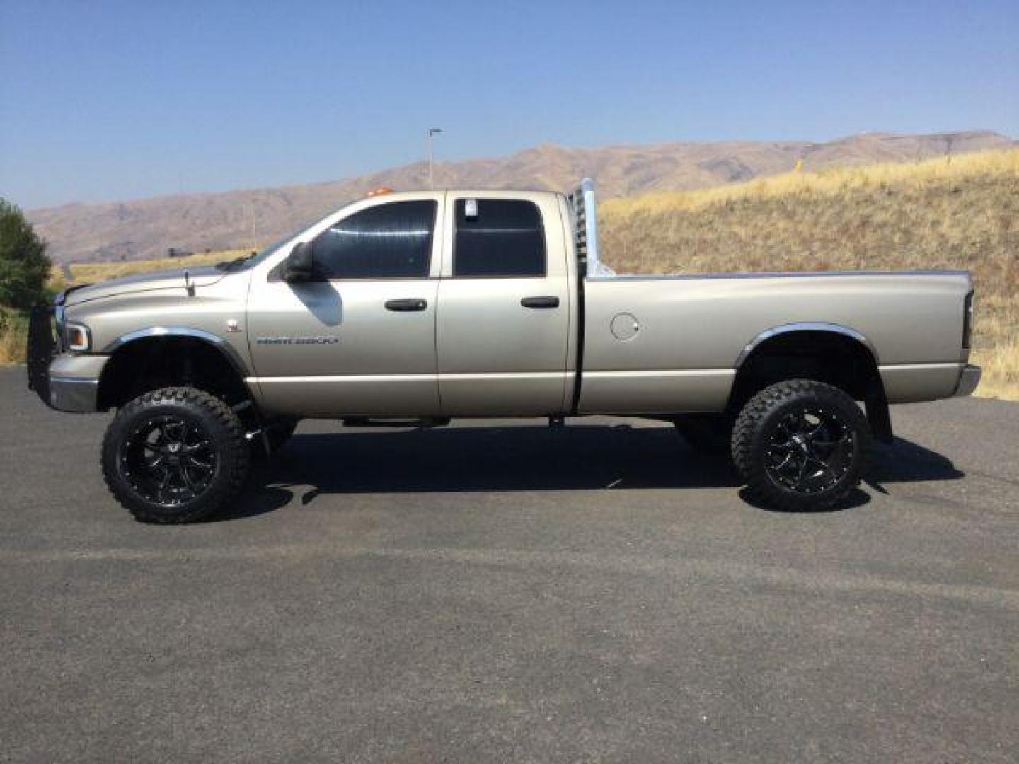 2005 Light Almond Pearl Metallic /Taupe Cloth Interior Dodge Ram 3500 SLT Quad Cab Long Bed 4WD (3D7LS38C25G) with an 5.9L L6 OHV 24V TURBO DIESEL engine, 6-Speed Manual transmission, located at 1801 Main Street, Lewiston, 83501, (208) 743-9371, 46.417065, -117.004799 - Photo#1