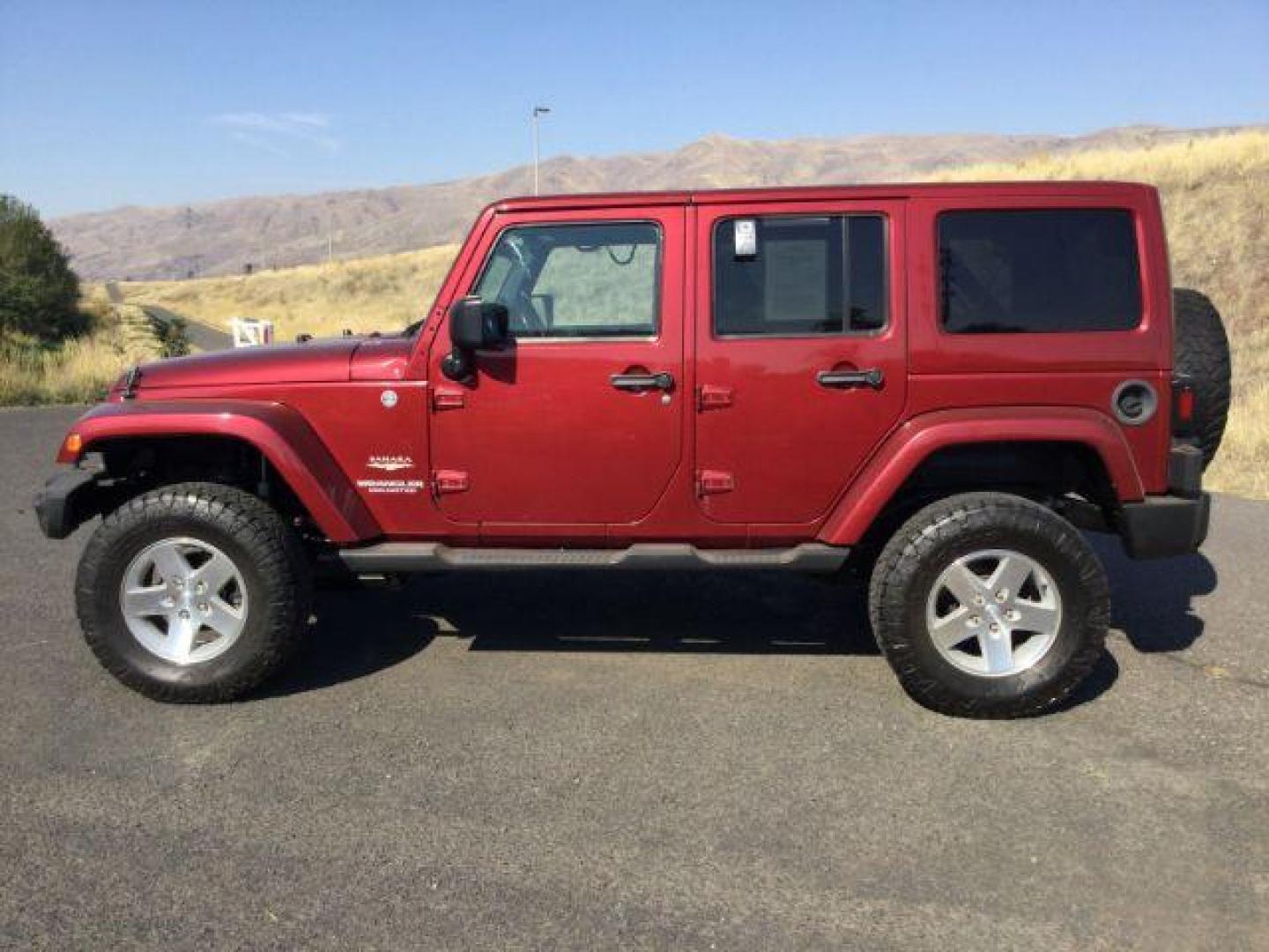 2011 Deep Cherry Red Crystal Pearl /Black Cloth Interior Jeep Wrangler Unlimited Sahara 4WD (1J4BA5H18BL) with an 3.8L V6 OHV 12V engine, 4-Speed Automatic transmission, located at 1801 Main Street, Lewiston, 83501, (208) 743-9371, 46.417065, -117.004799 - Photo#1