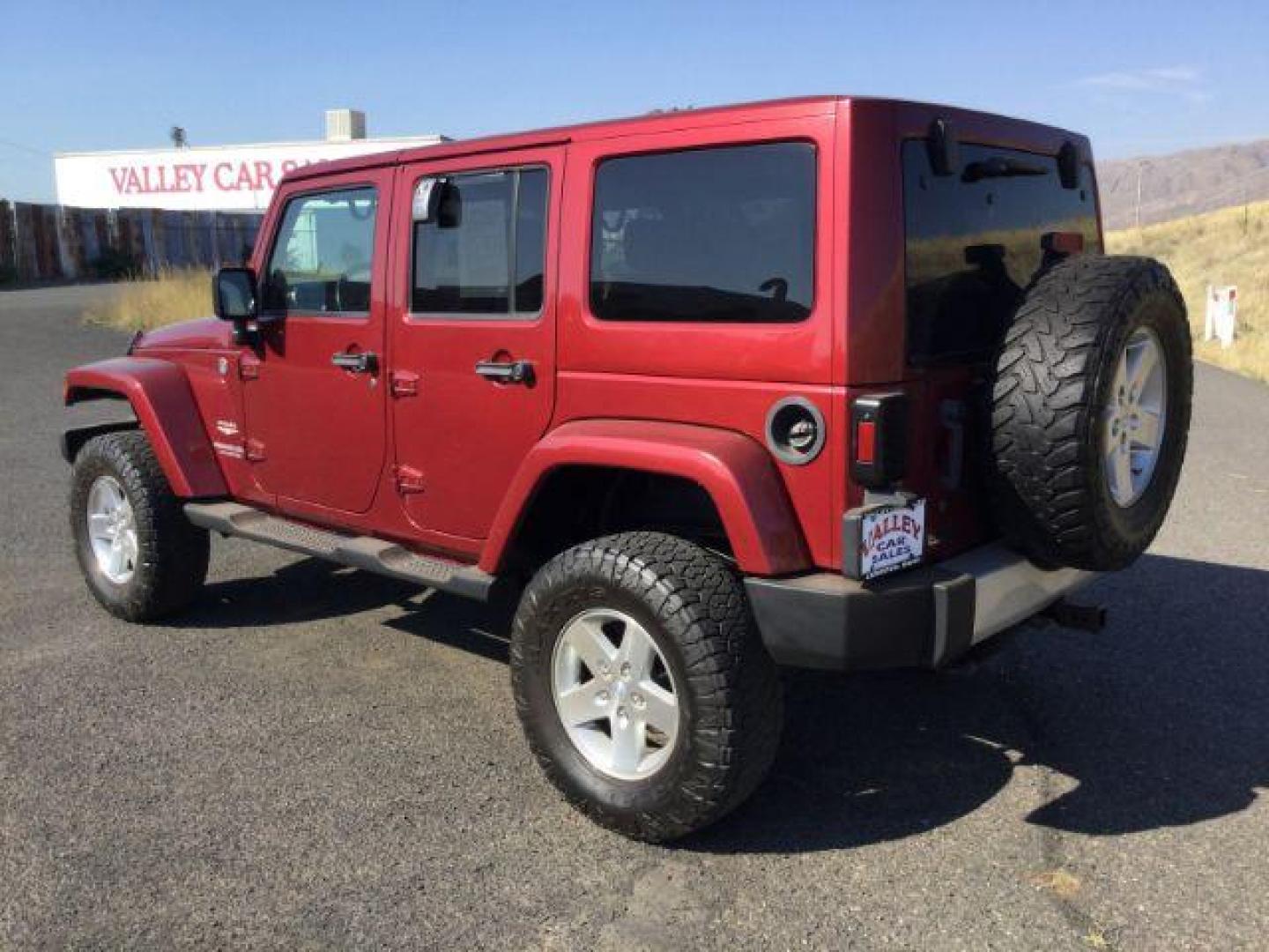 2011 Deep Cherry Red Crystal Pearl /Black Cloth Interior Jeep Wrangler Unlimited Sahara 4WD (1J4BA5H18BL) with an 3.8L V6 OHV 12V engine, 4-Speed Automatic transmission, located at 1801 Main Street, Lewiston, 83501, (208) 743-9371, 46.417065, -117.004799 - Photo#2