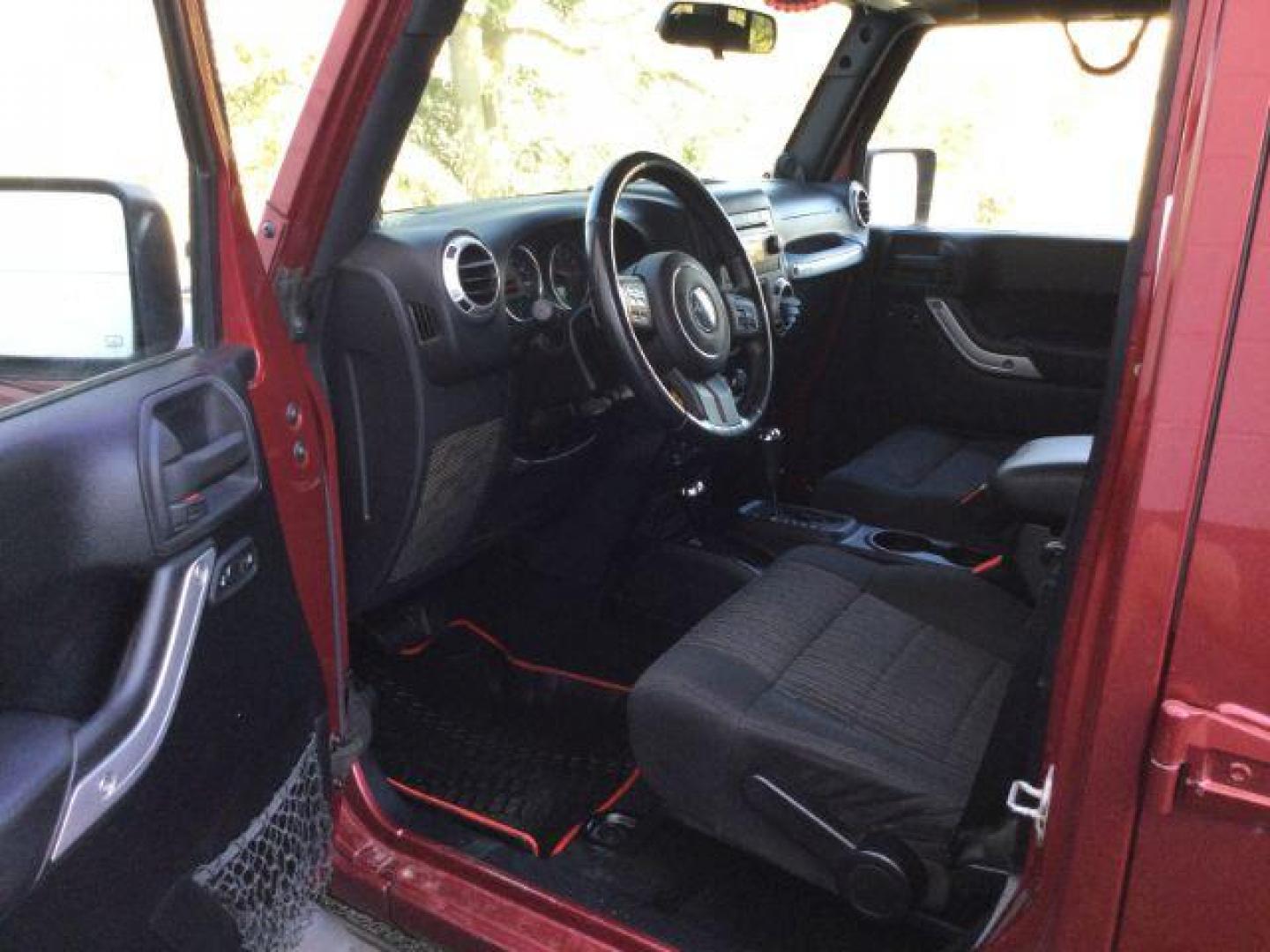 2011 Deep Cherry Red Crystal Pearl /Black Cloth Interior Jeep Wrangler Unlimited Sahara 4WD (1J4BA5H18BL) with an 3.8L V6 OHV 12V engine, 4-Speed Automatic transmission, located at 1801 Main Street, Lewiston, 83501, (208) 743-9371, 46.417065, -117.004799 - Photo#4