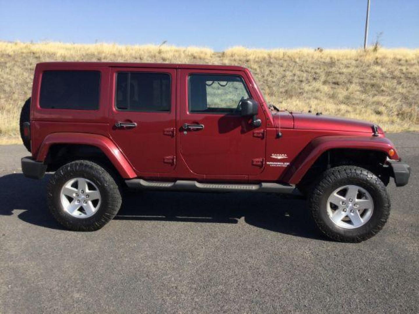 2011 Deep Cherry Red Crystal Pearl /Black Cloth Interior Jeep Wrangler Unlimited Sahara 4WD (1J4BA5H18BL) with an 3.8L V6 OHV 12V engine, 4-Speed Automatic transmission, located at 1801 Main Street, Lewiston, 83501, (208) 743-9371, 46.417065, -117.004799 - Photo#8