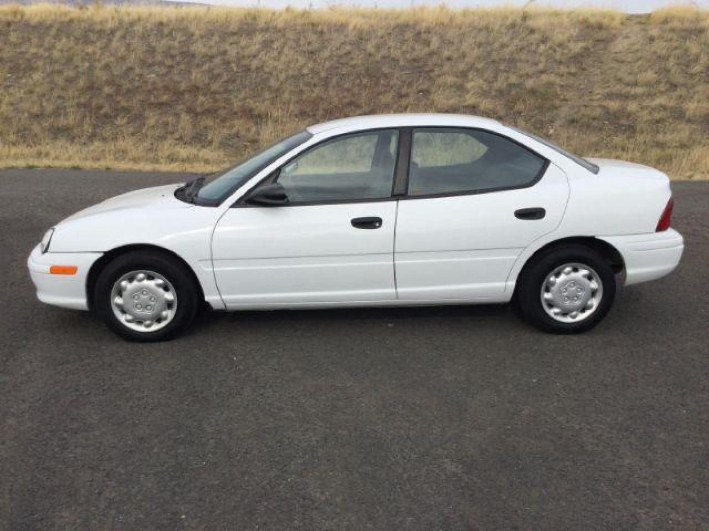 1997 White /Dark Gray Cloth Dodge Neon Sedan (1B3ES27C7VD) with an 2.0L L4 SOHC 16V engine, 3-Speed Automatic transmission, located at 1801 Main Street, Lewiston, 83501, (208) 743-9371, 46.417065, -117.004799 - Photo#1