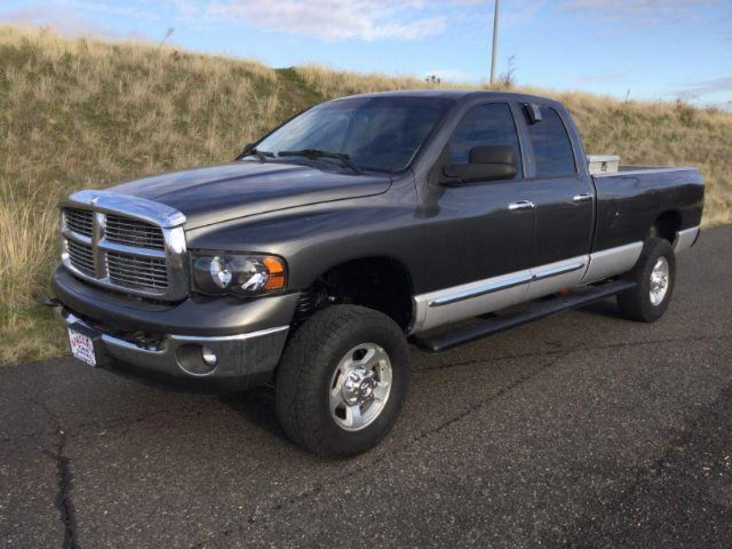 2004 Graphite Metallic/Bright Silver Metallic /Dark Slate Gray Leather Interior Dodge Ram 2500 Laramie Quad Cab Long Bed 4WD (3D7KU28C24G) with an 5.9L L6 OHV 24V TURBO DIESEL engine, 4-Speed Automatic transmission, located at 1801 Main Street, Lewiston, 83501, (208) 743-9371, 46.417065, -117.004799 - Photo#0