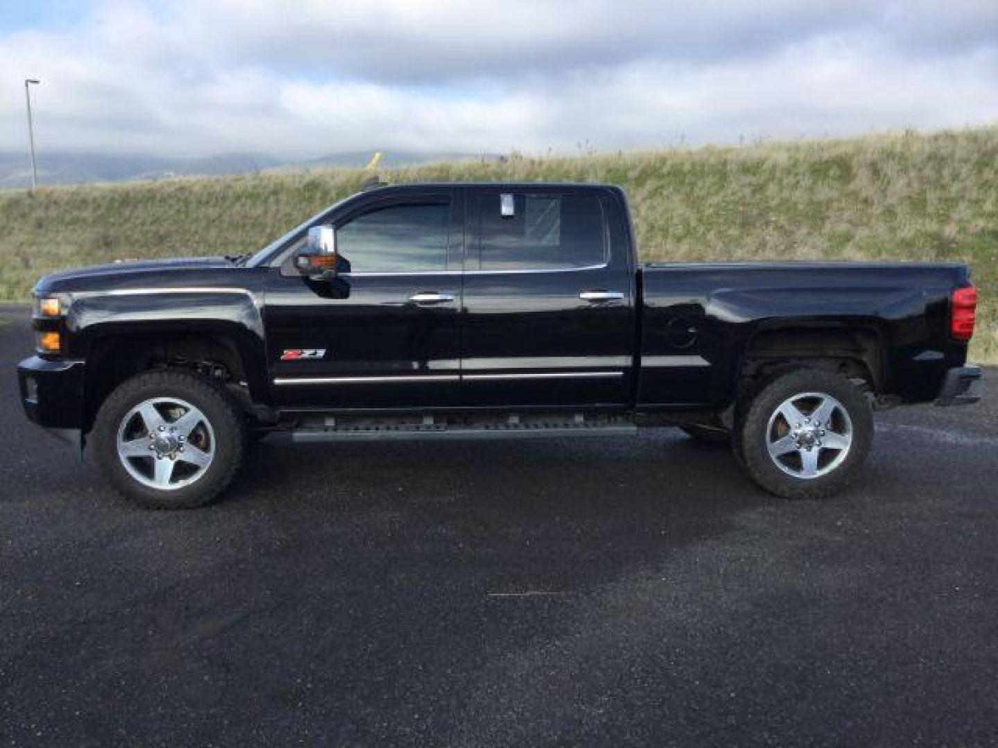 2015 Black /Jet Black Chevrolet Silverado 2500HD LTZ Crew Cab 4WD (1GC1KWE83FF) with an 6.6L V8 OHV 32V TURBO DIESEL engine, 6-Speed Automatic transmission, located at 1801 Main Street, Lewiston, 83501, (208) 743-9371, 46.417065, -117.004799 - Photo#1