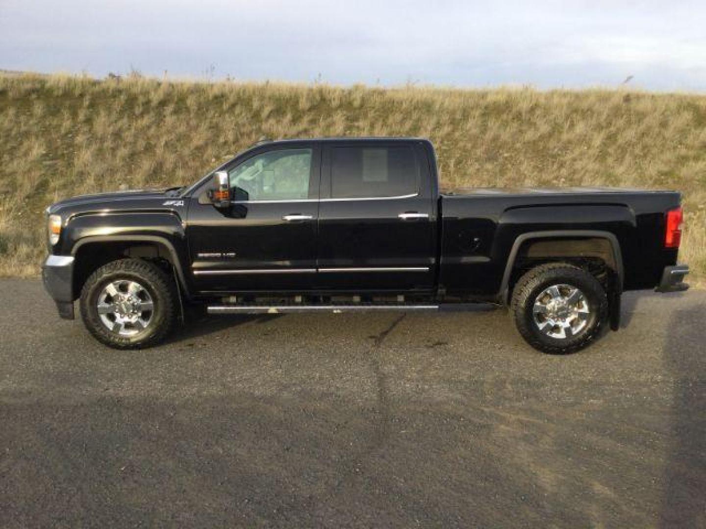 2016 Onyx Black /Jet Black, leather GMC Sierra 3500HD SLT Crew Cab 4WD (1GT42XE82GF) with an 6.6L V8 OHV 16 DIESEL engine, 6-Speed Automatic transmission, located at 1801 Main Street, Lewiston, 83501, (208) 743-9371, 46.417065, -117.004799 - Photo#1